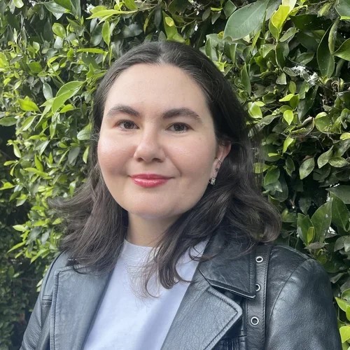 Kyla Gelev, grad student in Pajukanta lab, featured in front of green shrubbery